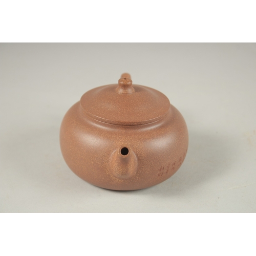 1294 - A CHINESE YIXING TEAPOT, with incised calligraphy, impressed marks to inner lid and base.