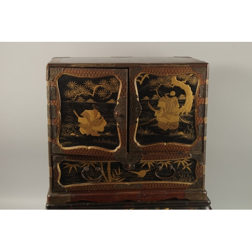 1060 - A FINE JAPANESE MEIJI PERIOD BLACK AND GILT LACQUERED CABINET, raised on stand, the two doors openin... 