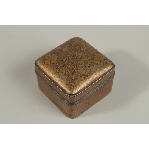 1070 - A JAPANESE MEIJI GILT LACQUER BOX, with floral decoration and pewter rim, 7.5cm x 7.5cm.