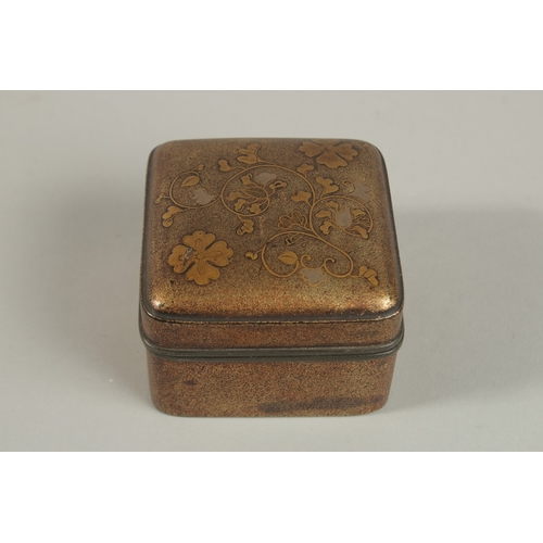 1070 - A JAPANESE MEIJI GILT LACQUER BOX, with floral decoration and pewter rim, 7.5cm x 7.5cm.