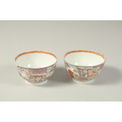 1074 - A PAIR OF CHINESE EXPORT PORCELAIN CUPS, each painted with scenes of figures, 8.5cm diameter.