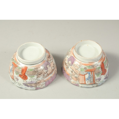 1074 - A PAIR OF CHINESE EXPORT PORCELAIN CUPS, each painted with scenes of figures, 8.5cm diameter.