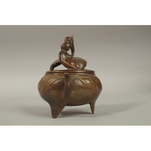 1214 - A CHINESE BRASS TWIN HANDLE CENSER AND COVER, 11cm high.