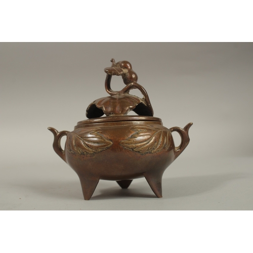 1214 - A CHINESE BRASS TWIN HANDLE CENSER AND COVER, 11cm high.