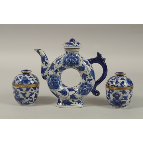 1272 - A CHINESE BLUE AND WHITE PORCELAIN PIERCED CENTRE TEAPOT, together with associated pair of lidded po... 