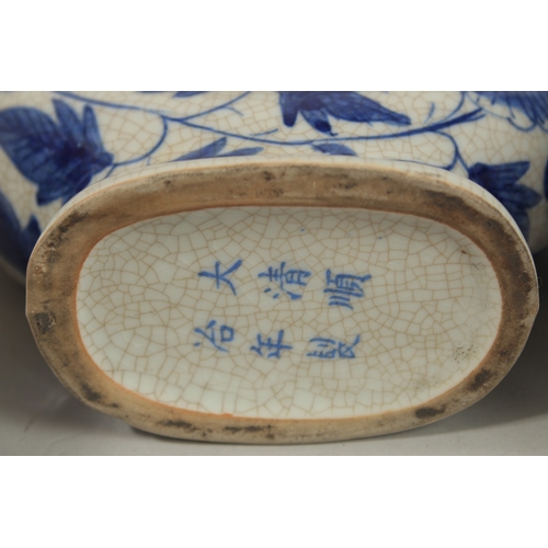 1272 - A CHINESE BLUE AND WHITE PORCELAIN PIERCED CENTRE TEAPOT, together with associated pair of lidded po... 