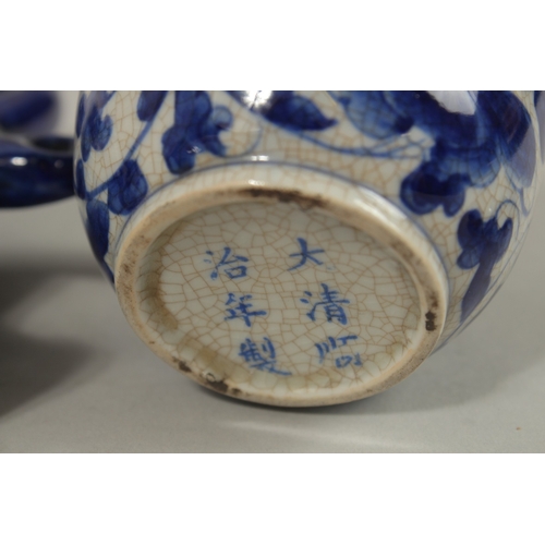 1272 - A CHINESE BLUE AND WHITE PORCELAIN PIERCED CENTRE TEAPOT, together with associated pair of lidded po... 