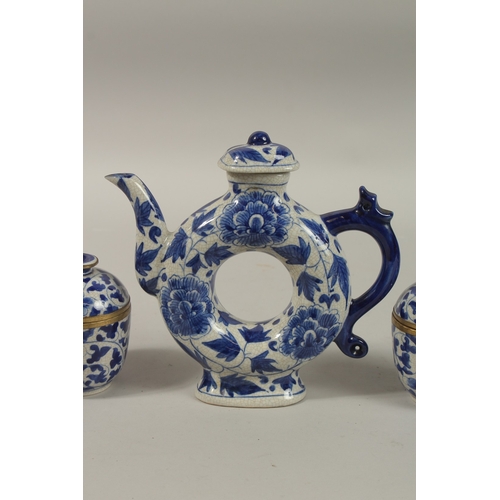 1272 - A CHINESE BLUE AND WHITE PORCELAIN PIERCED CENTRE TEAPOT, together with associated pair of lidded po... 