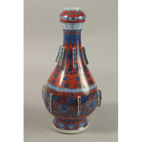 1276 - A CHINESE COPPER RED GROUND BLUE AND WHITE PORCELAIN VASE, painted with auspicious symbols and flora... 