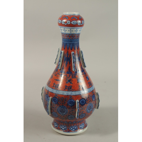 1276 - A CHINESE COPPER RED GROUND BLUE AND WHITE PORCELAIN VASE, painted with auspicious symbols and flora... 