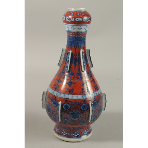 1276 - A CHINESE COPPER RED GROUND BLUE AND WHITE PORCELAIN VASE, painted with auspicious symbols and flora... 