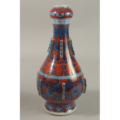 1276 - A CHINESE COPPER RED GROUND BLUE AND WHITE PORCELAIN VASE, painted with auspicious symbols and flora... 