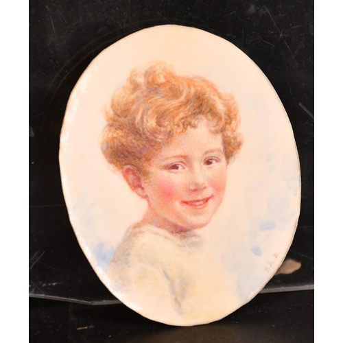 162 - Two miniature watercolours on ivorine of a smiling young boy, one signed with initials, each 3