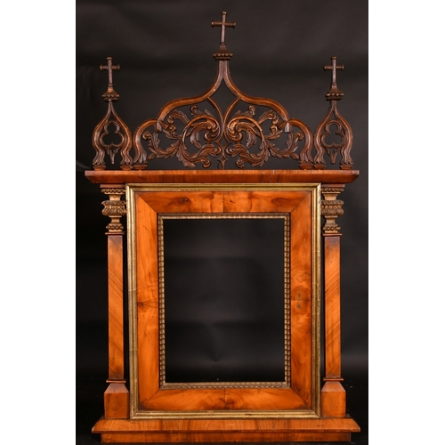 27 - A 19th Century Italian walnut tabernacle frame with carved scrolling top ornament, rebate size 15