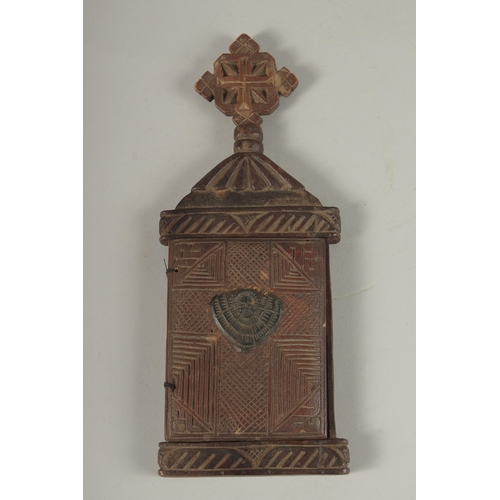 100 - A FINE 19TH CENTURY ETHIOPIAN CARVED WOODEN ICON, the interior with painted panel of Christ, 28cm hi... 