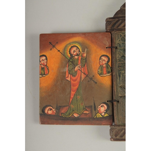 100 - A FINE 19TH CENTURY ETHIOPIAN CARVED WOODEN ICON, the interior with painted panel of Christ, 28cm hi... 