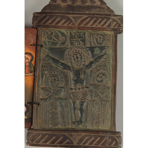 100 - A FINE 19TH CENTURY ETHIOPIAN CARVED WOODEN ICON, the interior with painted panel of Christ, 28cm hi... 