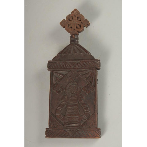 100 - A FINE 19TH CENTURY ETHIOPIAN CARVED WOODEN ICON, the interior with painted panel of Christ, 28cm hi... 