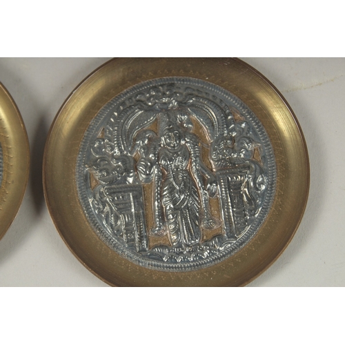 108 - A PAIR OF 19TH CENTURY INDIAN TANJORE SILVER MOUNTED BRASS DISHES, 8.5cm diameter each.