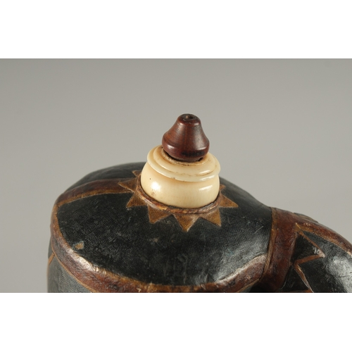 120 - A FINE 18TH-19TH CENTURY MUGHAL INDIAN LEATHER MOUNTED POWDER FLASK, 16cm high.