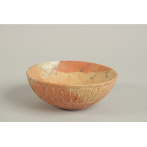 151 - A PERSIAN SIGNED CARVED STONE BOWL, with radiating sun design to the exterior, the base with incised... 