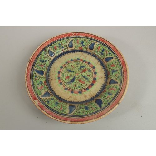 152 - AN EARLY PERSIAN GLAZED POTTERY DISH, painted with foliate designs, 19cm diameter.