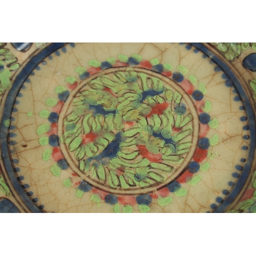 152 - AN EARLY PERSIAN GLAZED POTTERY DISH, painted with foliate designs, 19cm diameter.