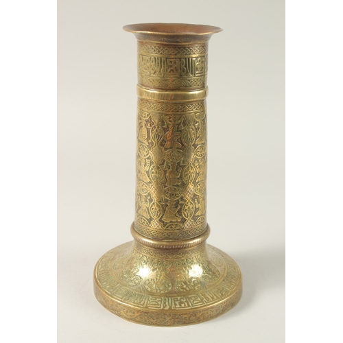 154 - A FINE 19TH CENTURY PERSIAN BRASS CANDLESTICK WITH SILVER INLAYS, the body engraved with seated figu... 