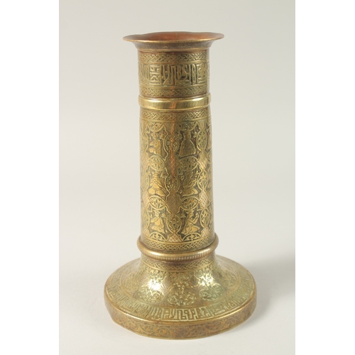 154 - A FINE 19TH CENTURY PERSIAN BRASS CANDLESTICK WITH SILVER INLAYS, the body engraved with seated figu... 