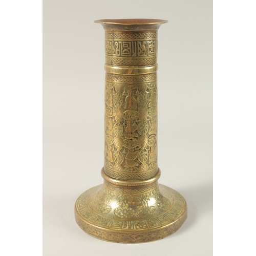 154 - A FINE 19TH CENTURY PERSIAN BRASS CANDLESTICK WITH SILVER INLAYS, the body engraved with seated figu... 