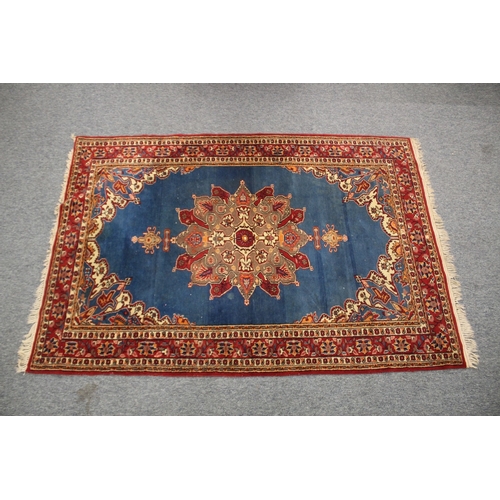 156 - A PERSIAN BLUE GROUND AND RED DESIGN RUG, 180cm x 122cm.