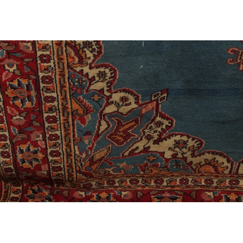 156 - A PERSIAN BLUE GROUND AND RED DESIGN RUG, 180cm x 122cm.