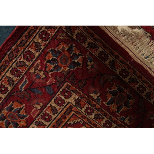 156 - A PERSIAN BLUE GROUND AND RED DESIGN RUG, 180cm x 122cm.