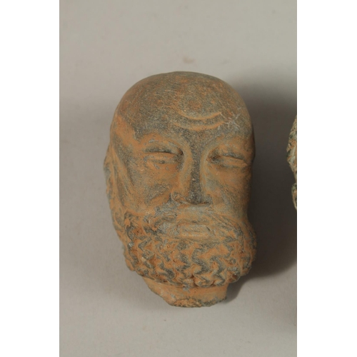 157 - A GROUP OF THREE INDIAN GANDHARA CARVED HEADS, buddha 9.5cm high, (3).