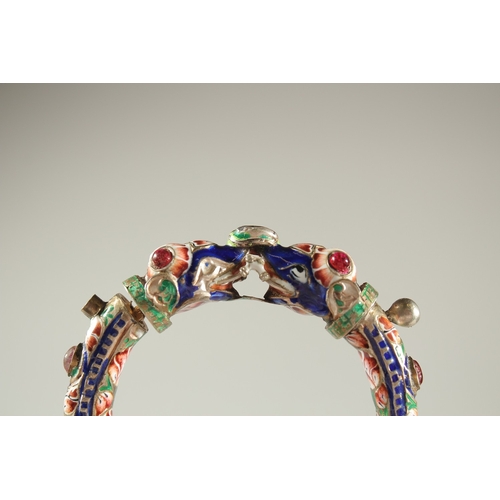 160 - A VERY FINE 19TH CENTURY INDIAN ENAMELLED SILVER BANGLE, with two elephant heads, inset with red sto... 