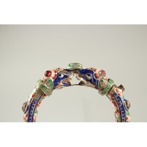 160 - A VERY FINE 19TH CENTURY INDIAN ENAMELLED SILVER BANGLE, with two elephant heads, inset with red sto... 