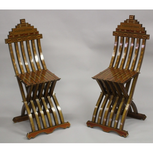 165 - A PAIR OF MOROCCAN MARQUETRY INLAID WOODEN FOLDING CHAIRS.