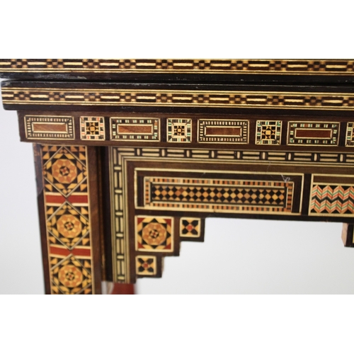 166 - A MOROCCAN MARQUETRY INLAID FOLDING GAMES TABLE, with open-out inset top and folding out leg.