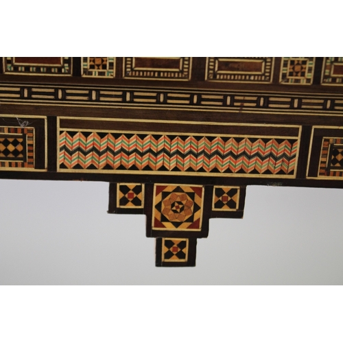 166 - A MOROCCAN MARQUETRY INLAID FOLDING GAMES TABLE, with open-out inset top and folding out leg.