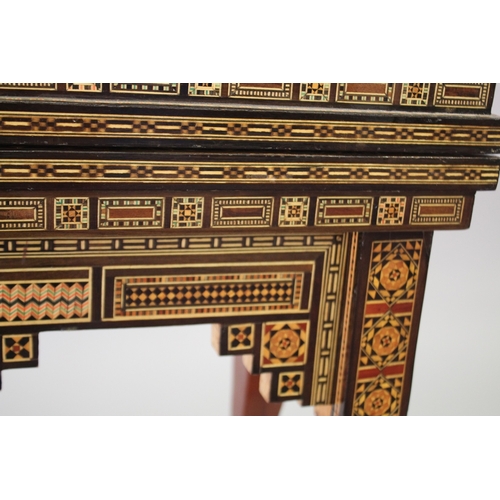 166 - A MOROCCAN MARQUETRY INLAID FOLDING GAMES TABLE, with open-out inset top and folding out leg.