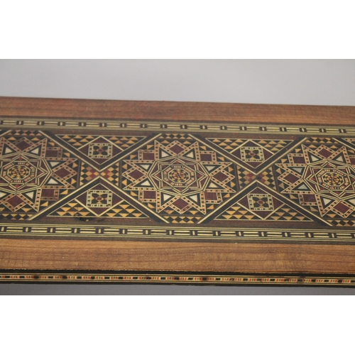 166 - A MOROCCAN MARQUETRY INLAID FOLDING GAMES TABLE, with open-out inset top and folding out leg.