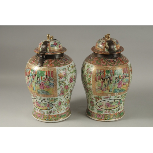 176 - A GOOD PAIR OF 18TH CENTURY CANTON ENAMELLED GINGER JARS AND COVERS, with metal mounts, painted with... 