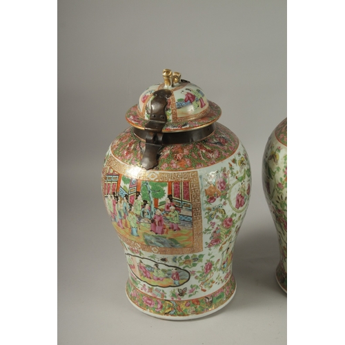 176 - A GOOD PAIR OF 18TH CENTURY CANTON ENAMELLED GINGER JARS AND COVERS, with metal mounts, painted with... 