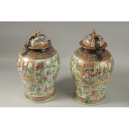 176 - A GOOD PAIR OF 18TH CENTURY CANTON ENAMELLED GINGER JARS AND COVERS, with metal mounts, painted with... 