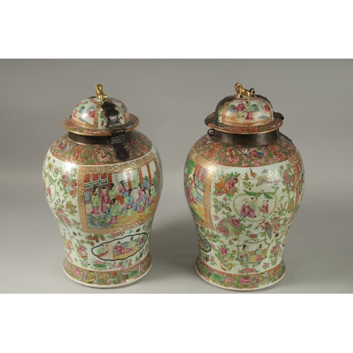 176 - A GOOD PAIR OF 18TH CENTURY CANTON ENAMELLED GINGER JARS AND COVERS, with metal mounts, painted with... 