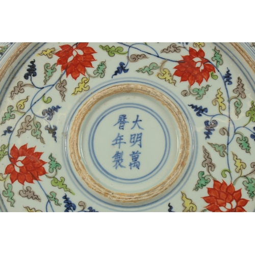 18 - A CHINESE DOUCAI PORCELAIN DRAGON CHARGER, the base with six-character mark, 40.5cm diameter.