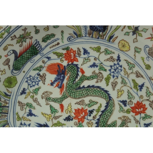 18 - A CHINESE DOUCAI PORCELAIN DRAGON CHARGER, the base with six-character mark, 40.5cm diameter.