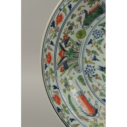 18 - A CHINESE DOUCAI PORCELAIN DRAGON CHARGER, the base with six-character mark, 40.5cm diameter.