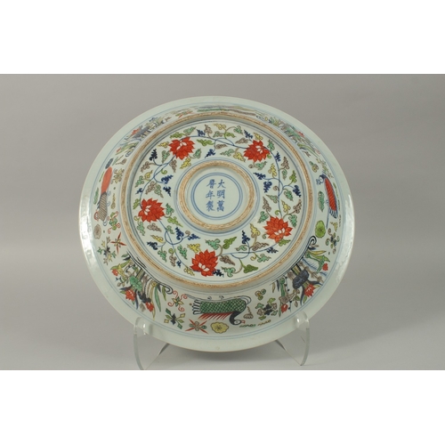 18 - A CHINESE DOUCAI PORCELAIN DRAGON CHARGER, the base with six-character mark, 40.5cm diameter.