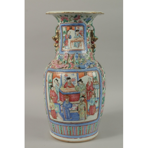 20 - A CHINESE FAMILLE ROSE PORCELAIN TWIN HANDLE VASE, with panels of figures, (af), 43cm high.